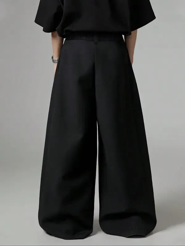 Detail of the waistband and pleats on women's high-rise wide-leg tailored trousers, made for a polished look.