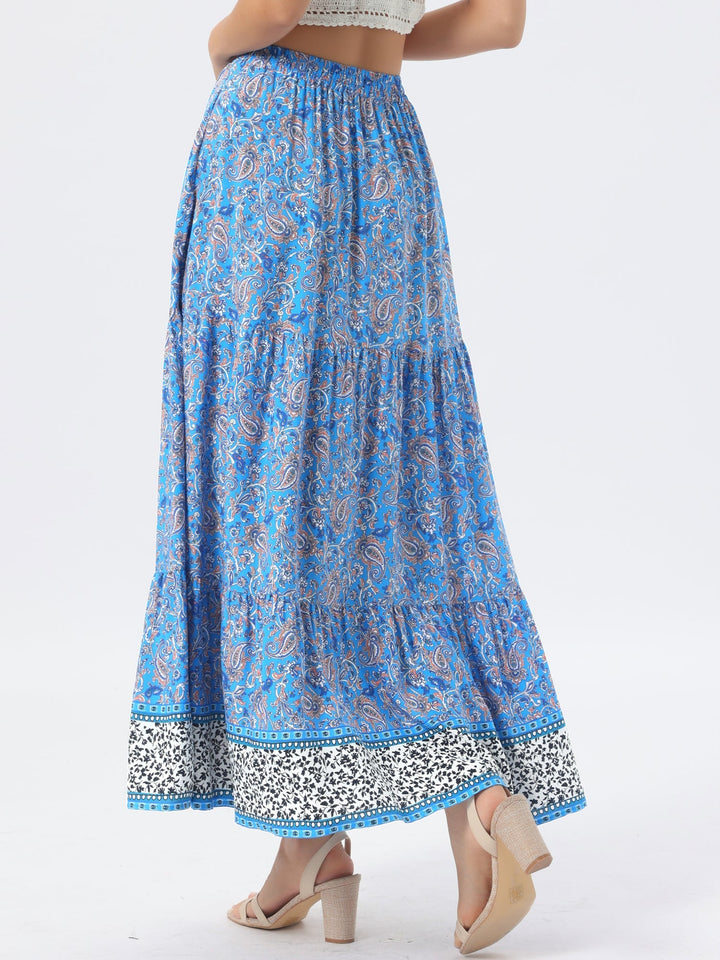 Women's printed high waist maxi skirt, featuring a flowing drape and a trendy side slit.