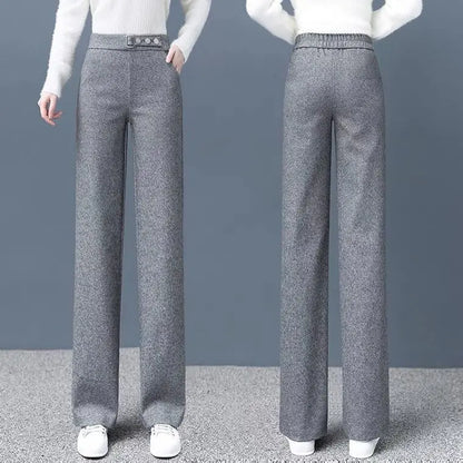 Sophisticated khaki Women's High-Waist Tailored Astoria Pants with a prominent statement belt for a chic look.
