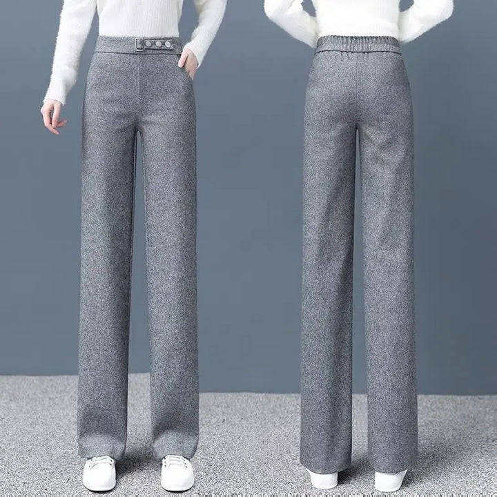 Sophisticated khaki Women's High-Waist Tailored Astoria Pants with a prominent statement belt for a chic look.