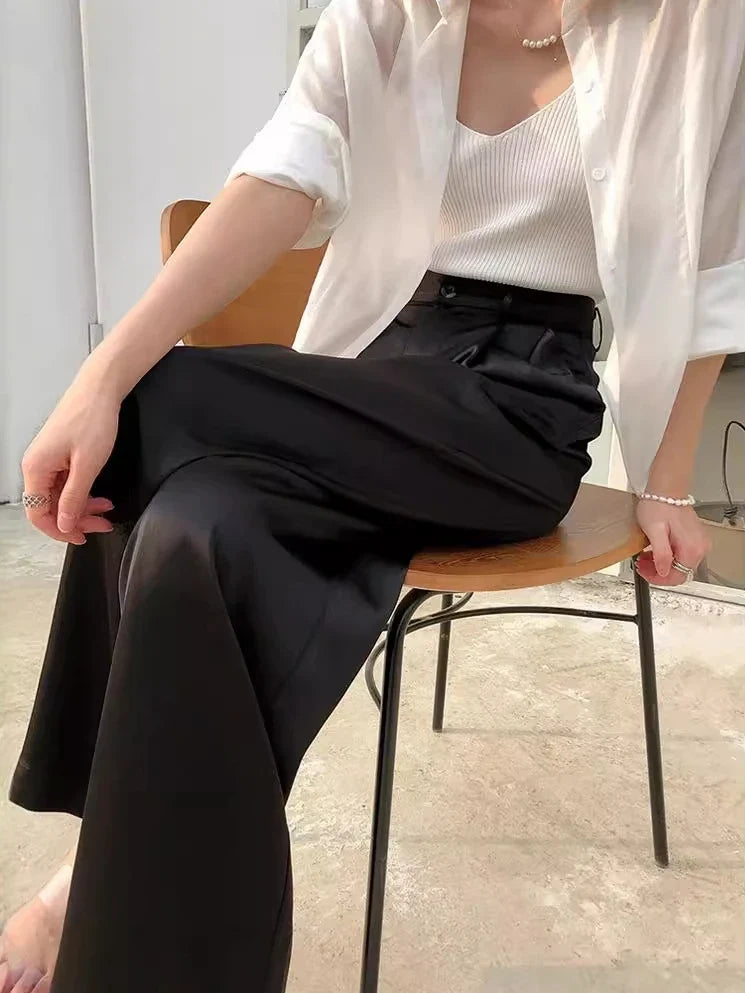 Woman wearing comfortable high waist wide leg flowy pants, perfect for spring outings.