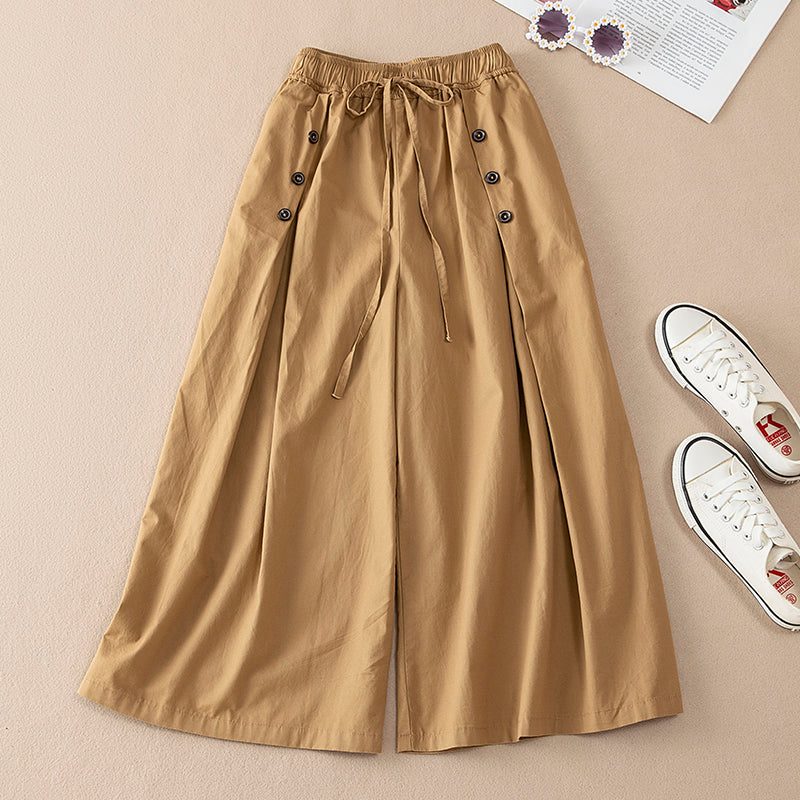 Woman wearing casual high-waist wide-leg pants, showcasing their elegant flow and comfortable, relaxed silhouette.