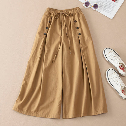 Woman wearing casual high-waist wide-leg pants, showcasing their elegant flow and comfortable, relaxed silhouette.
