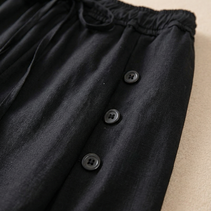 Back view of women's high-waist wide-leg pants, emphasizing the comfortable, relaxed fit and stylish, flowy silhouette.