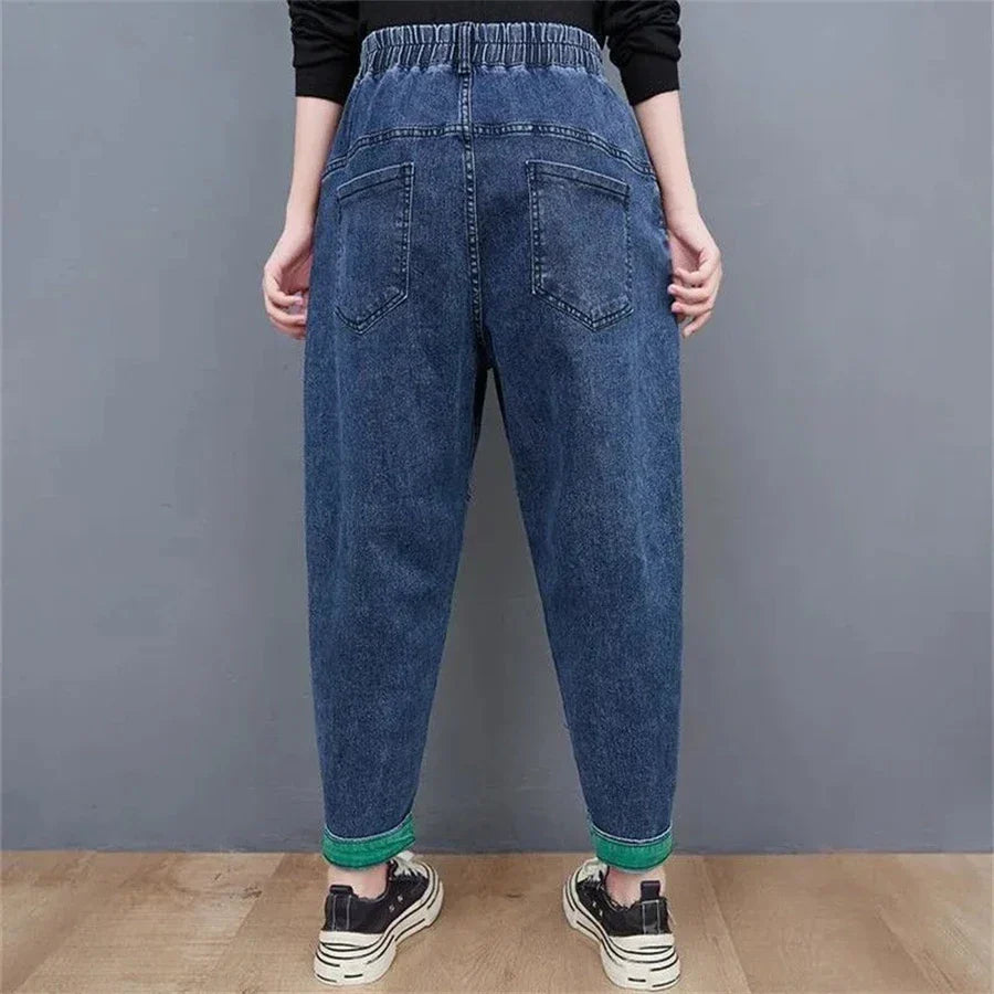 Back view of women's comfortable loose-fit denim jeans: high-waisted, baggy, & ankle-length for style.
