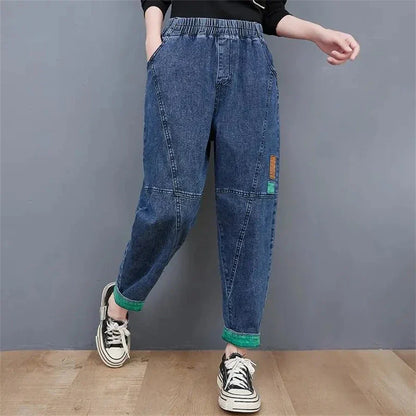 Detail shot of the ankle hem & baggy cut of women's high-waisted oversized jeans for a vintage look.