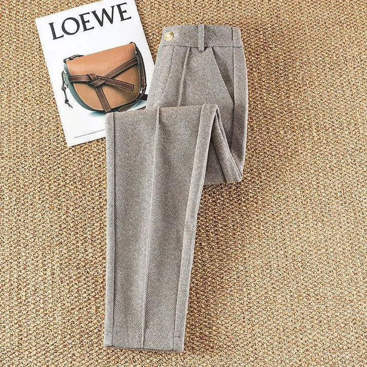 Close-up of women's herringbone tailored pants, showcasing the classic pattern & high-quality fabric.