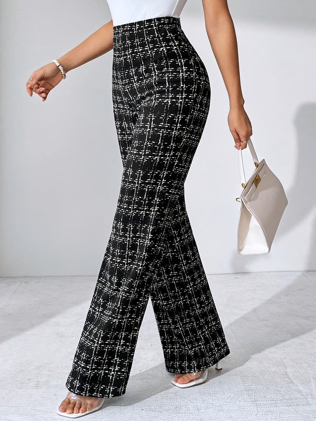Women's high-waisted plaid flare pants in a comfortable, wrinkle-resistant stretch knit fabric.