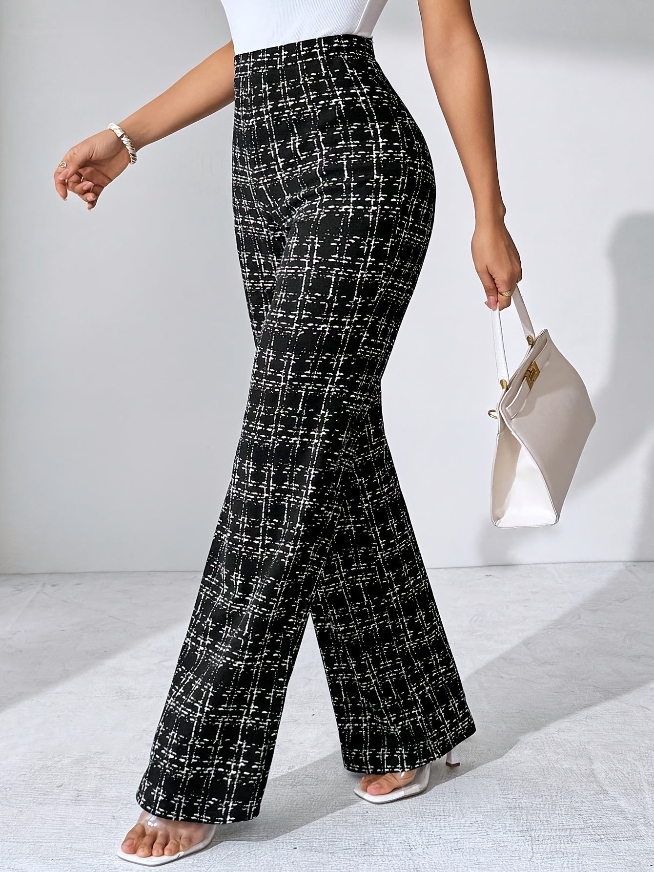 Women's high-waisted plaid flare pants in a comfortable, wrinkle-resistant stretch knit fabric.