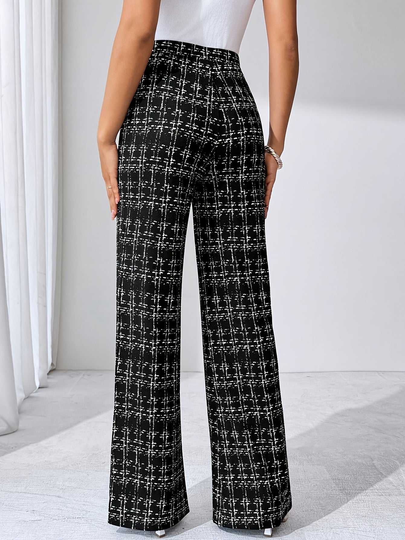 Stylish women's pull-on plaid flare pants with a high waist, made from soft stretch knit for comfort.