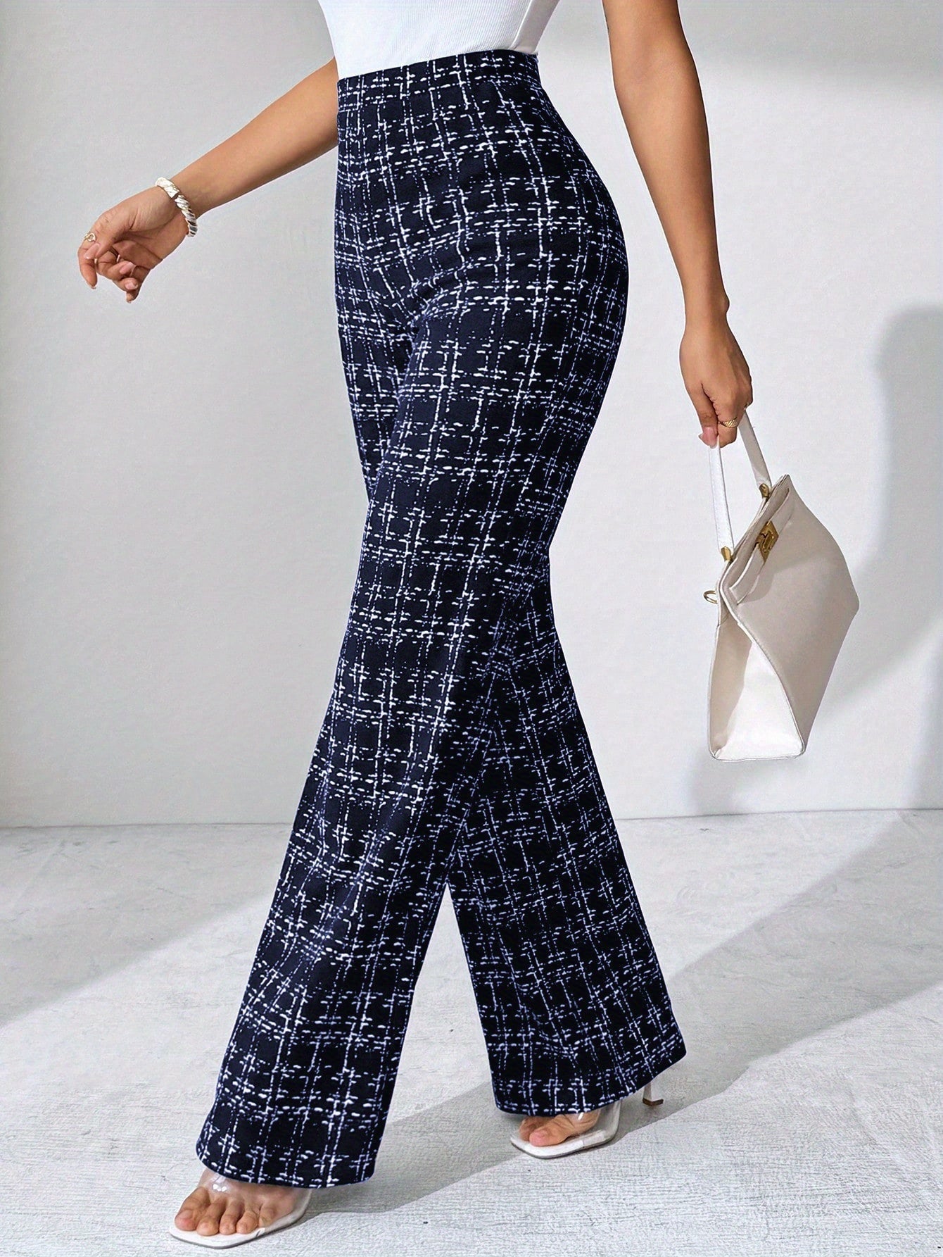 Chic women's high-waisted plaid flare pants; soft stretch knit for all-day comfort and style.