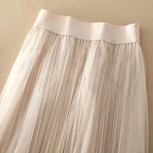 Trendy women's pleated midi skirt, high-waisted A-line design for modern spring fashion and casual style.