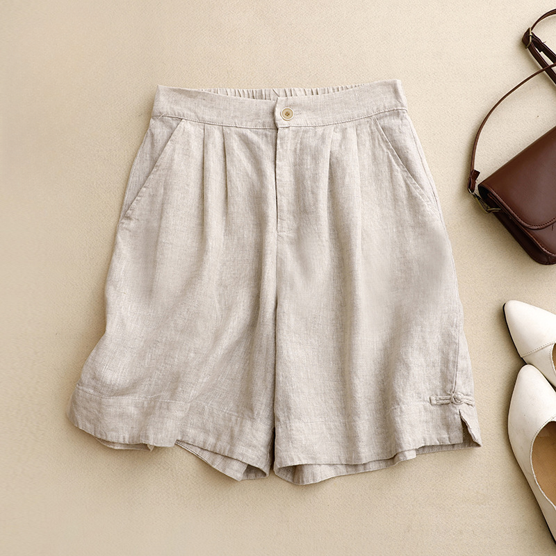 Brown high-waisted pleated summer shorts for women. Comfy, relaxed fit & tied hem detail, ideal for everyday style.