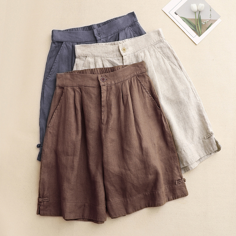 Blue women's high-waisted summer shorts. Pleated casual style with tied hem, great for warm weather & everyday fashion.