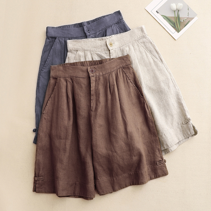 Blue women's high-waisted summer shorts. Pleated casual style with tied hem, great for warm weather & everyday fashion.