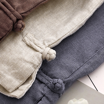 Close-up of women's high-waisted summer shorts showcasing pleats and stylish tied hem detail for a relaxed fit.