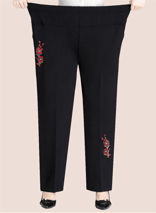 Women's high-waisted plus size pants with elegant floral embroidery, perfect for fall fashion.