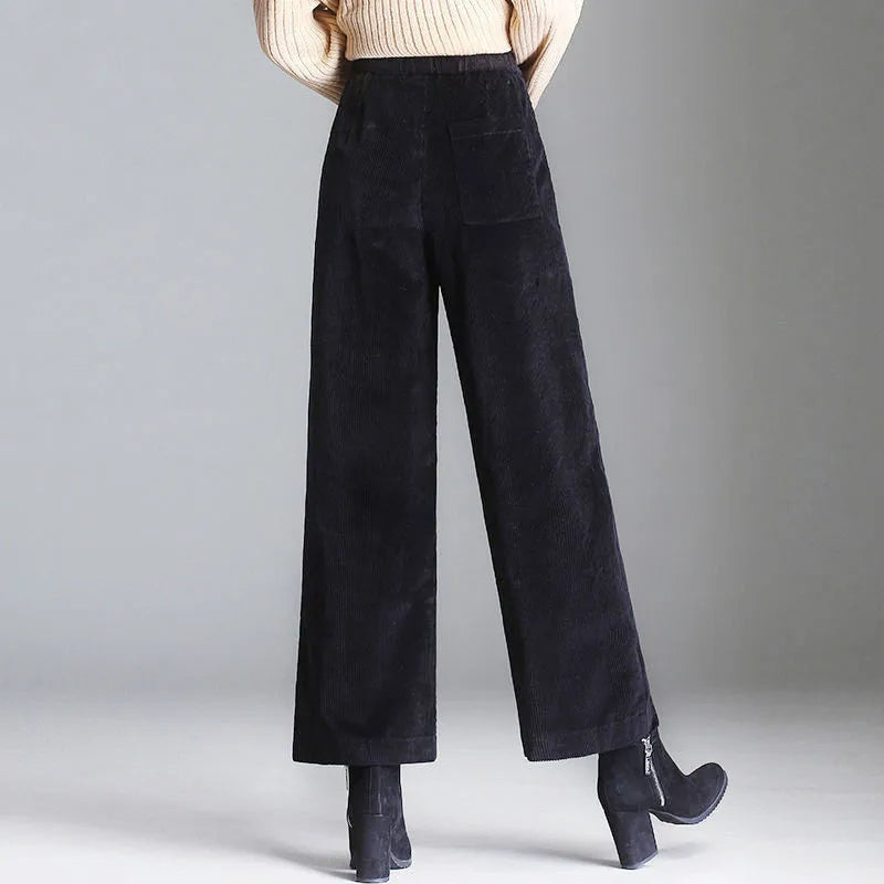 Full-length view of women's high-waisted retro flare trousers, showcasing their flattering cut & trendy style.