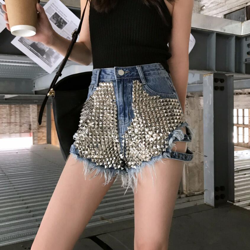 Trendy women's black high-waisted studded shorts with distressed details. A stylish choice for summer outfits.
