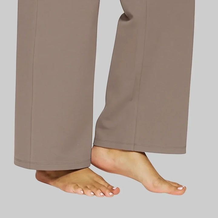 Comfortable women's high-waisted pants with wide legs & convenient side pockets for work.