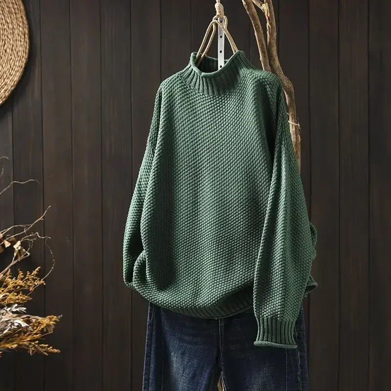Woman modeling a relaxed fit honeycomb knit pullover sweater, looking chic & cozy.