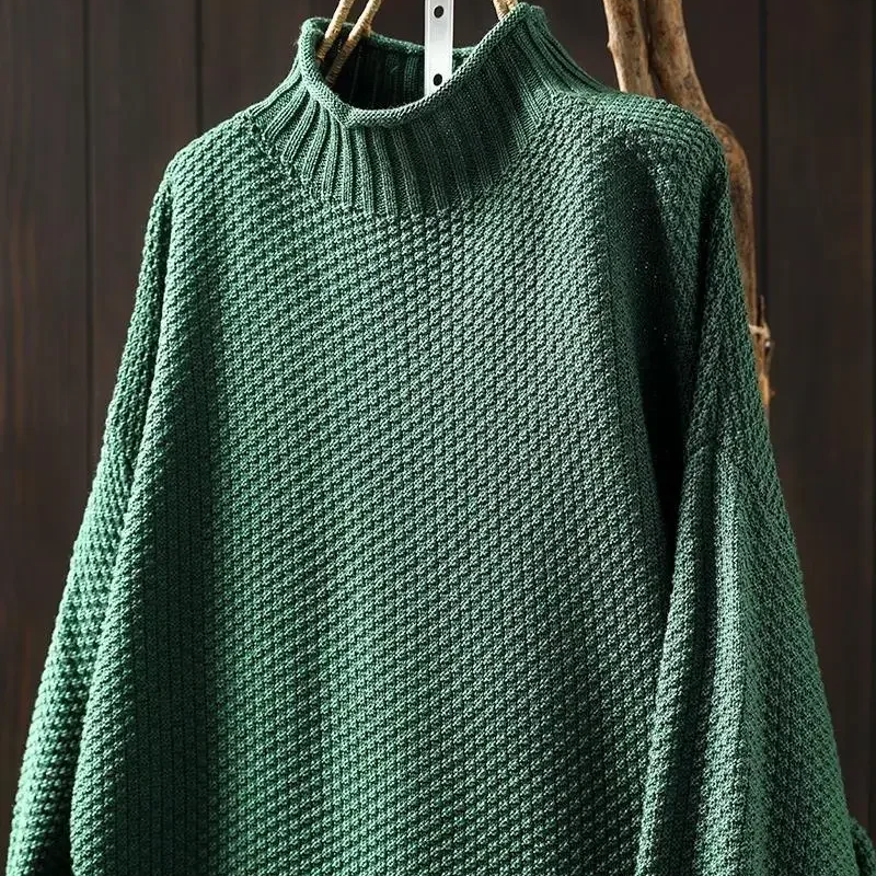 Back detail of women's long sleeve honeycomb knit sweater, highlighting its relaxed silhouette & texture.