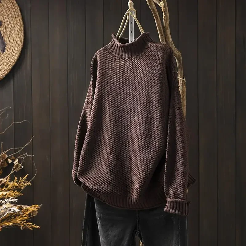 Close-up of women's honeycomb knit sweater, showcasing its unique textured pattern & quality.