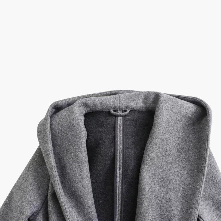 Elegant women's trench coat, featuring a protective hood, button-front, and flattering belt.