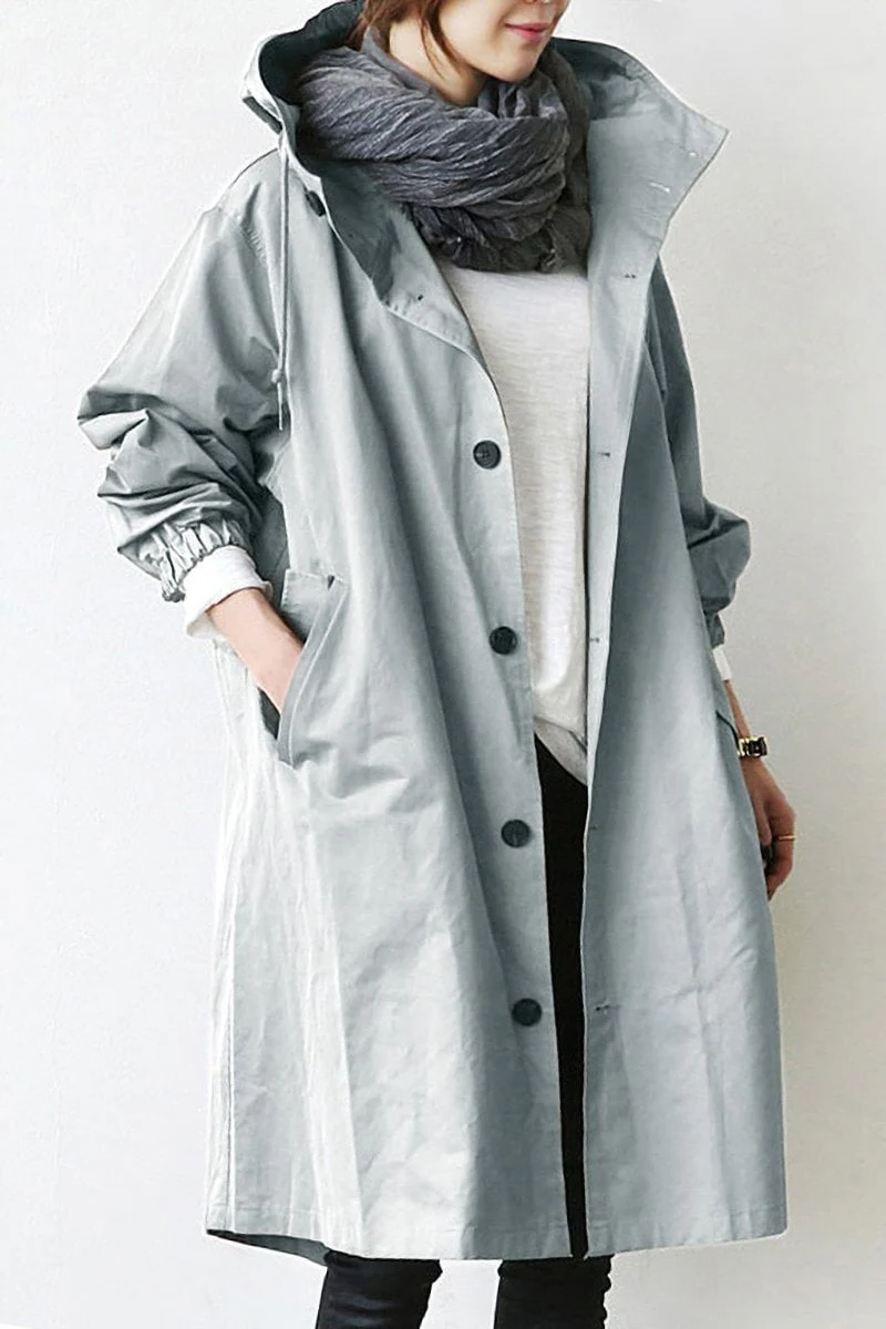 Chic women's waterproof long trench coat with hood, ideal for sophisticated fall fashion and daily wear in the rain.