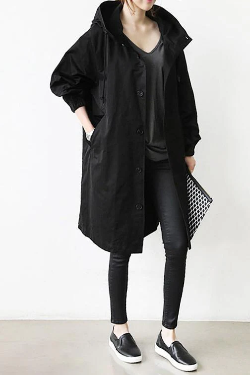 Versatile women's hooded rain jacket; an elegant waterproof trench coat for all-weather protection and style.