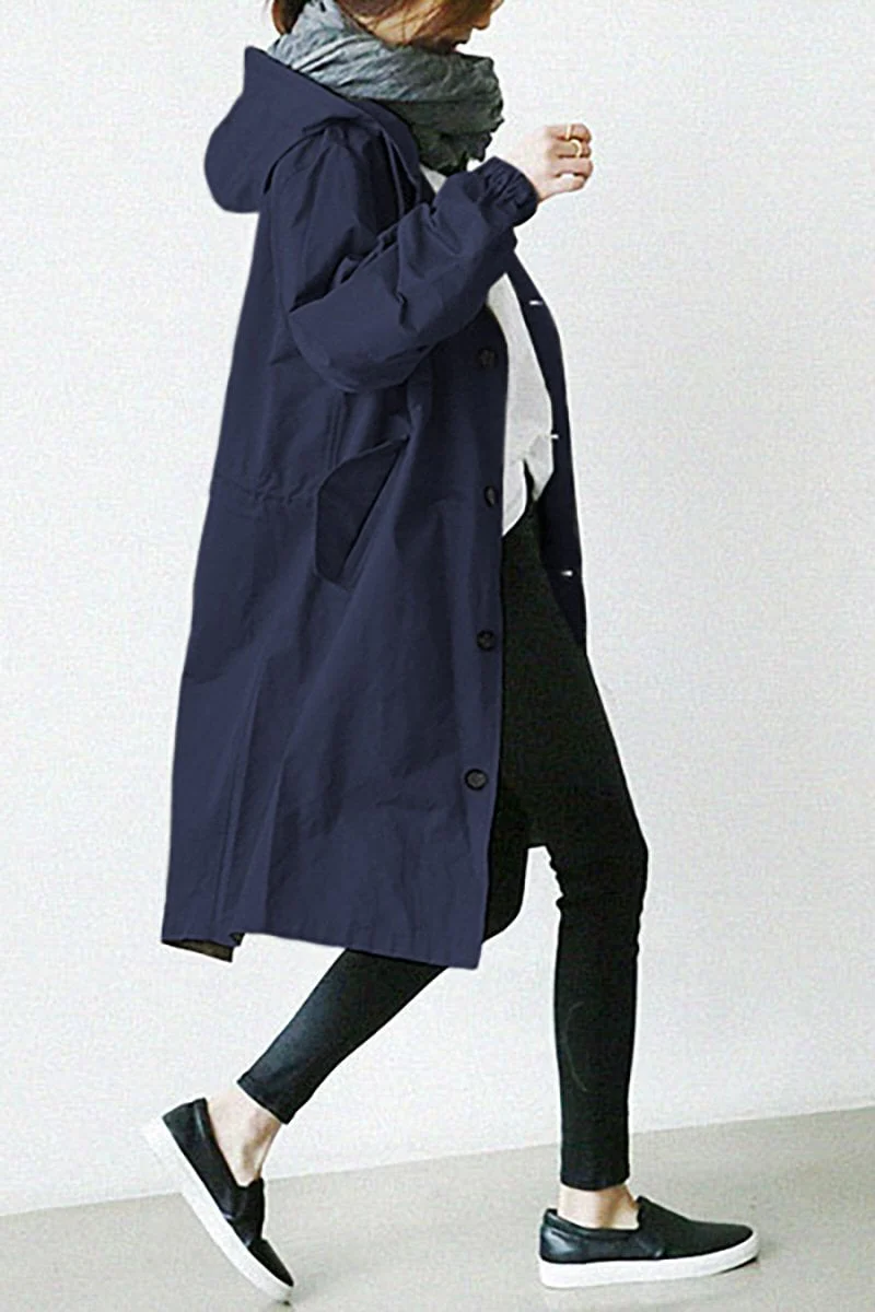 Sophisticated women's all-weather trench coat with hood, waterproof design for elegant protection and fall fashion.