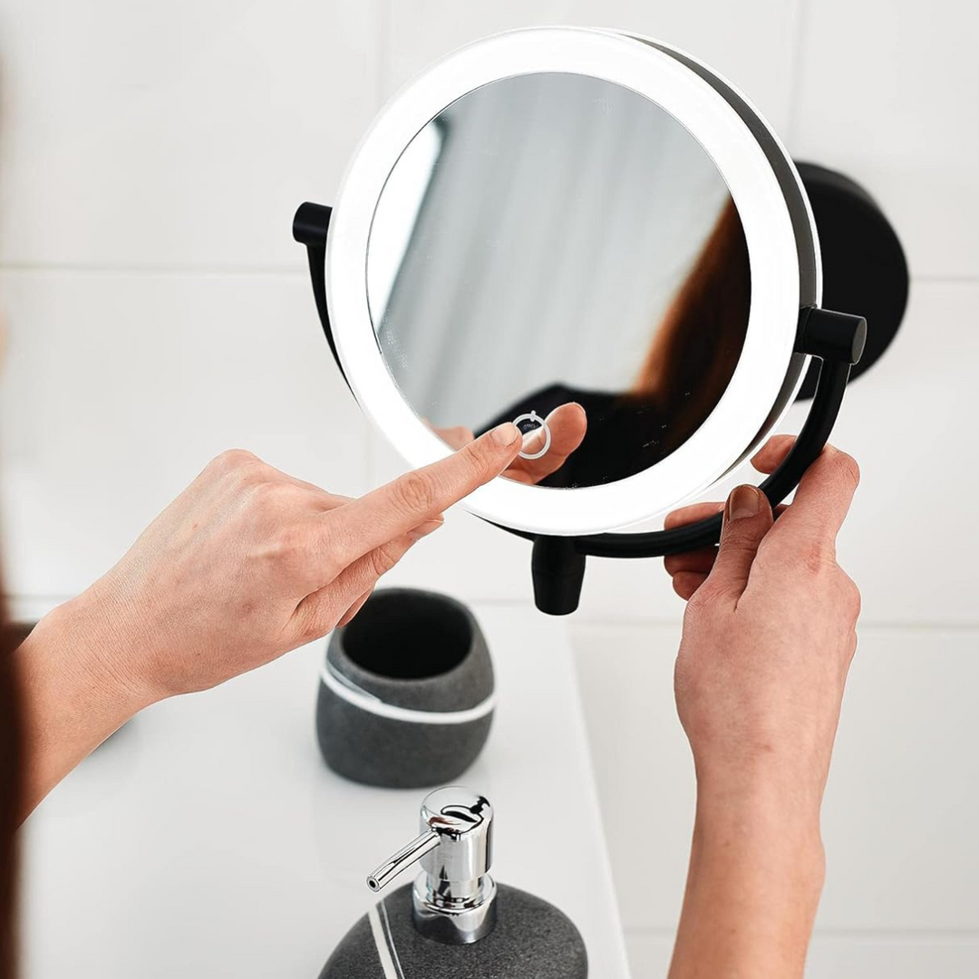 Elegant cosmetic vanity mirror with LED light, 3x magnification, portable design.