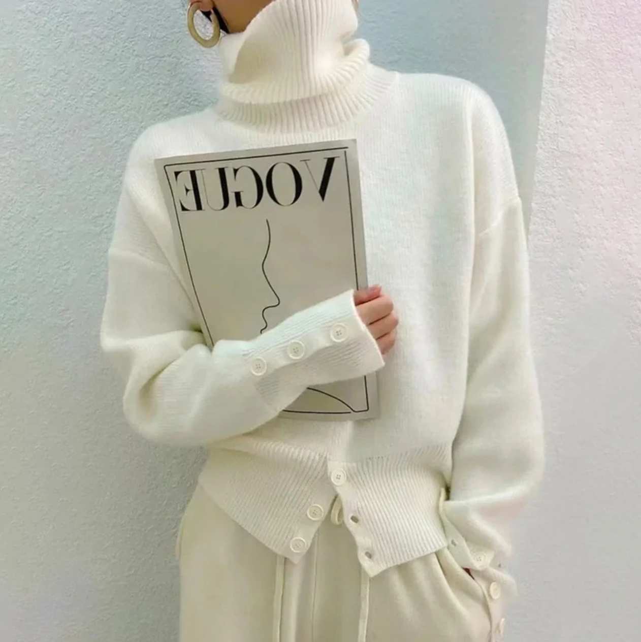 Women's ivory plain knit turtleneck sweater, a cozy long-sleeve top for elegant fall and winter fashion.