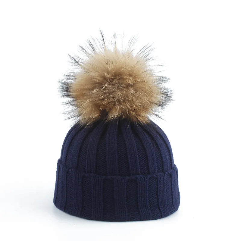 Fashionable women's knitted beanie with a fluffy faux fur pom-pom, chic winter accessory.
