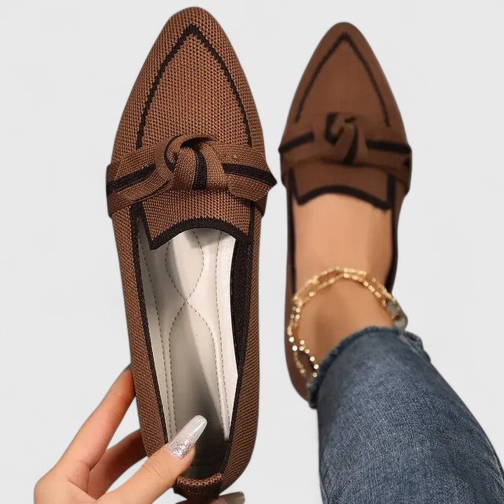 Chic women's flat loafers with a sophisticated knot-front and sharp pointed-toe design, ultimate fashion footwear.