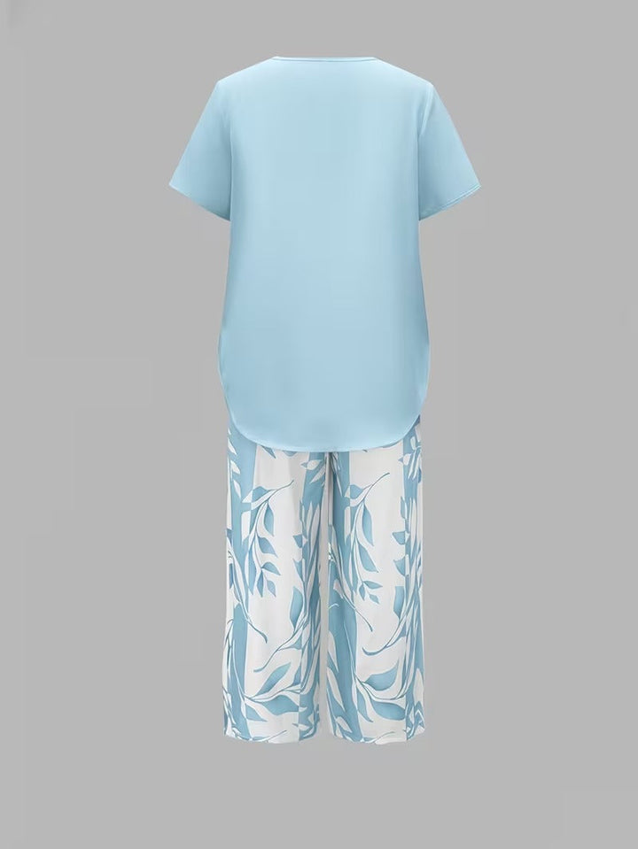 Women's casual leaf print matching set. Short sleeve top and cropped pants for relaxed wear.