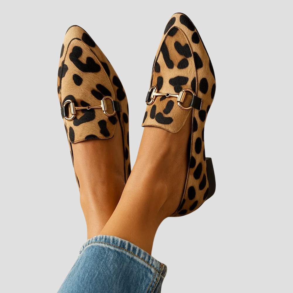 Women's leopard print pointed-toe loafers with gold horsebit detail. Elegant slip-on flats for office or casual chic.