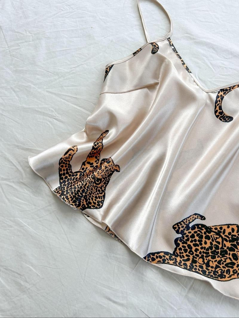 Luxurious women's leopard print silk satin two-piece pajama set. Stylish animal print sleepwear.