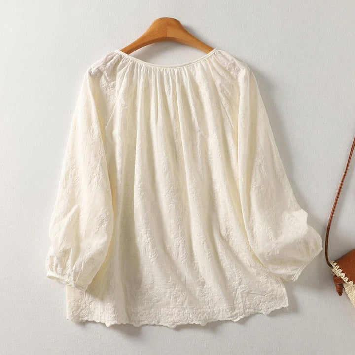 Elegant women's Lia blouse featuring intricate embroidery & stylish tie-neck, a perfect lightweight spring/summer top.