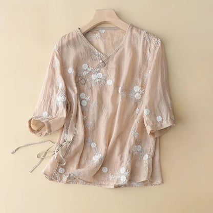 Elegant women's soft peach embroidered blouse. Romantic asymmetrical summer top with long sleeves.