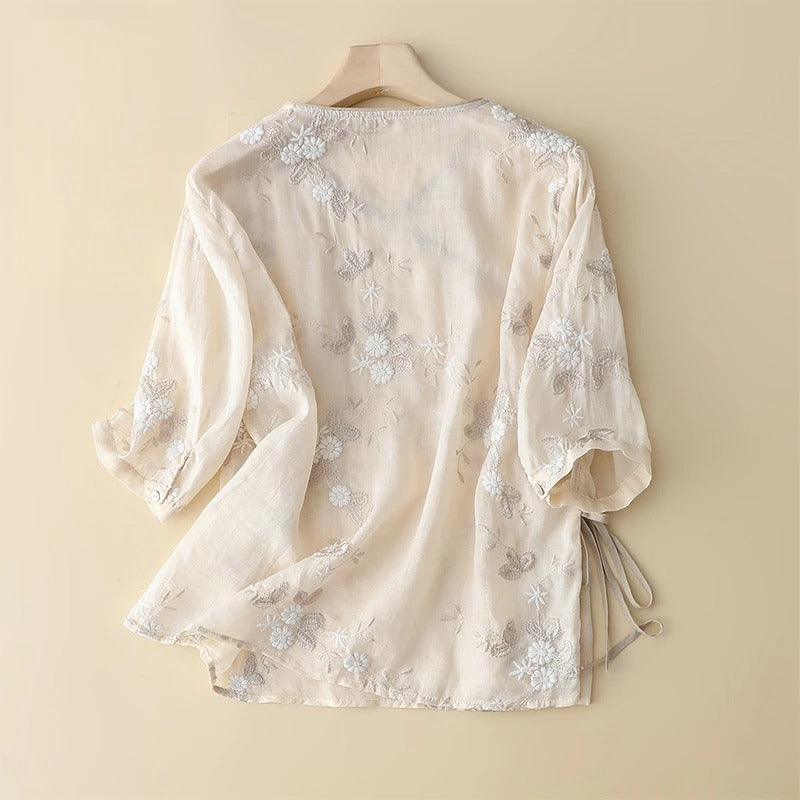 Flowy asymmetrical women's blouse in light beige with delicate embroidery. Perfect casual or elegant summer top.