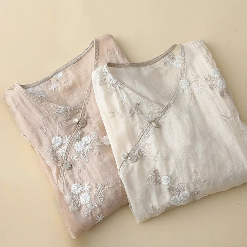 Chic women's light beige asymmetrical blouse with intricate embroidery. Versatile long sleeve top for summer elegance.