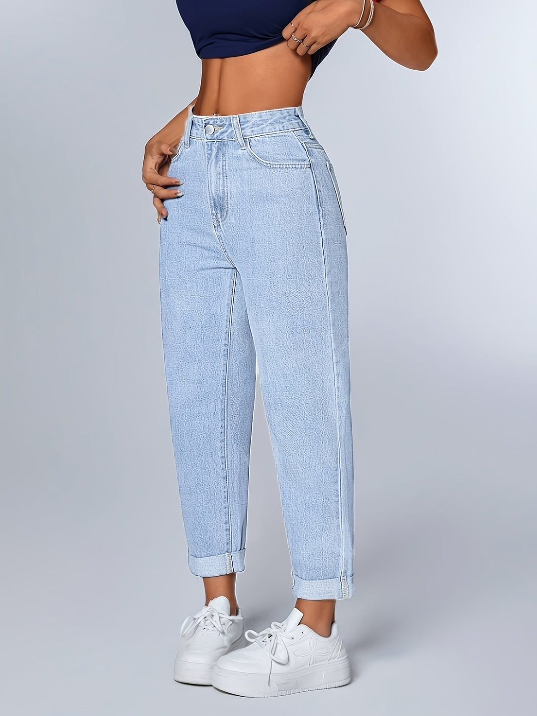 Women's light blue relaxed mom jeans with high waist, tapered leg, and cuffed hem. Perfect casual style.
