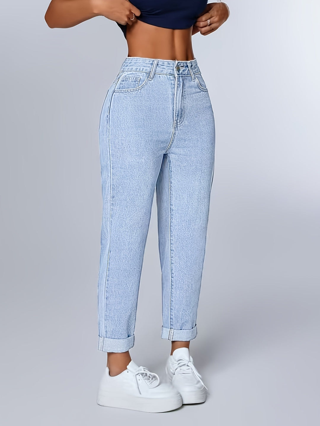 Casual retro light blue mom jeans. Women's relaxed fit denim with a flattering high waist and cuffed tapered leg.