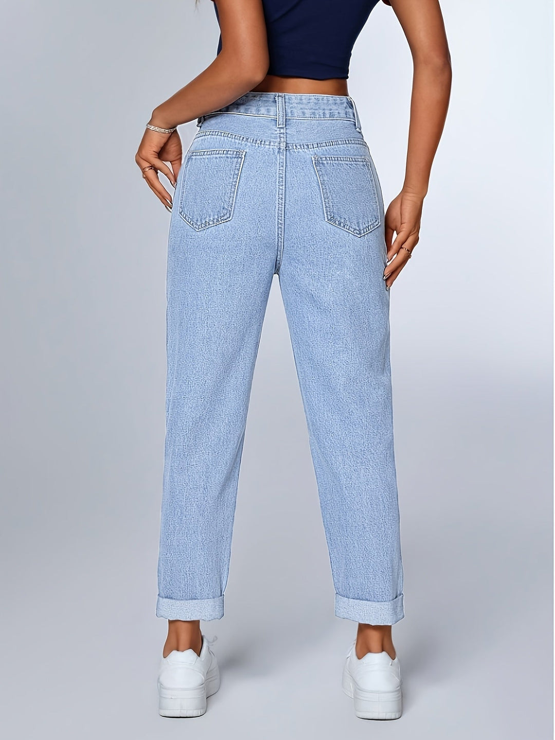 Stylish women's light blue relaxed mom jeans, high-waisted with a tapered leg and cuffed hem for everyday wear.
