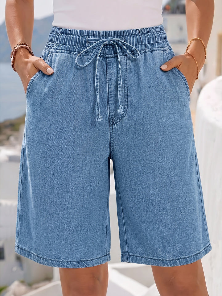 Relaxed fit light blue wide leg Bermuda shorts for women, featuring a stylish drawstring waist & soft fabric.