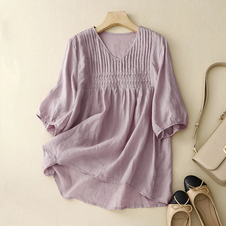 Stylish women's button-up shirt; lightweight, breathable fabric & long sleeves, ideal as a summer top.