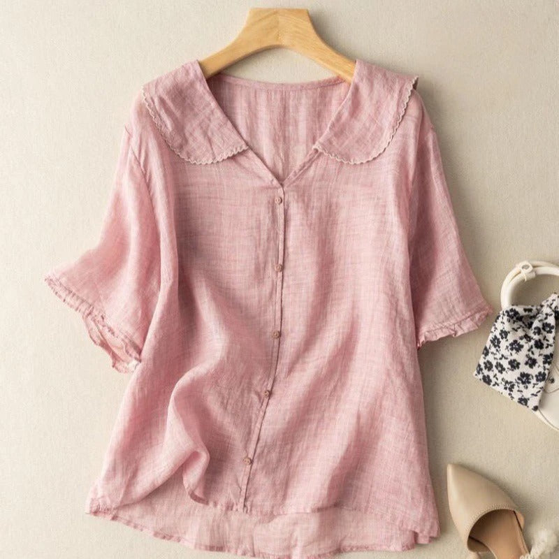 Model wearing a versatile women's lightweight breezy blouse with a unique scalloped collar. Spring/summer style.