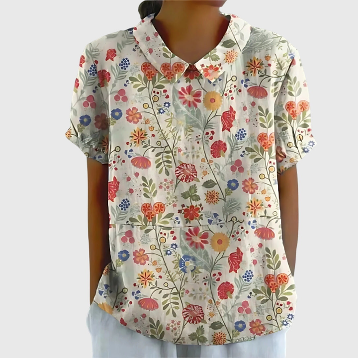 Lightweight short sleeve women's blouse with a delicate floral print, great for summer elegance.