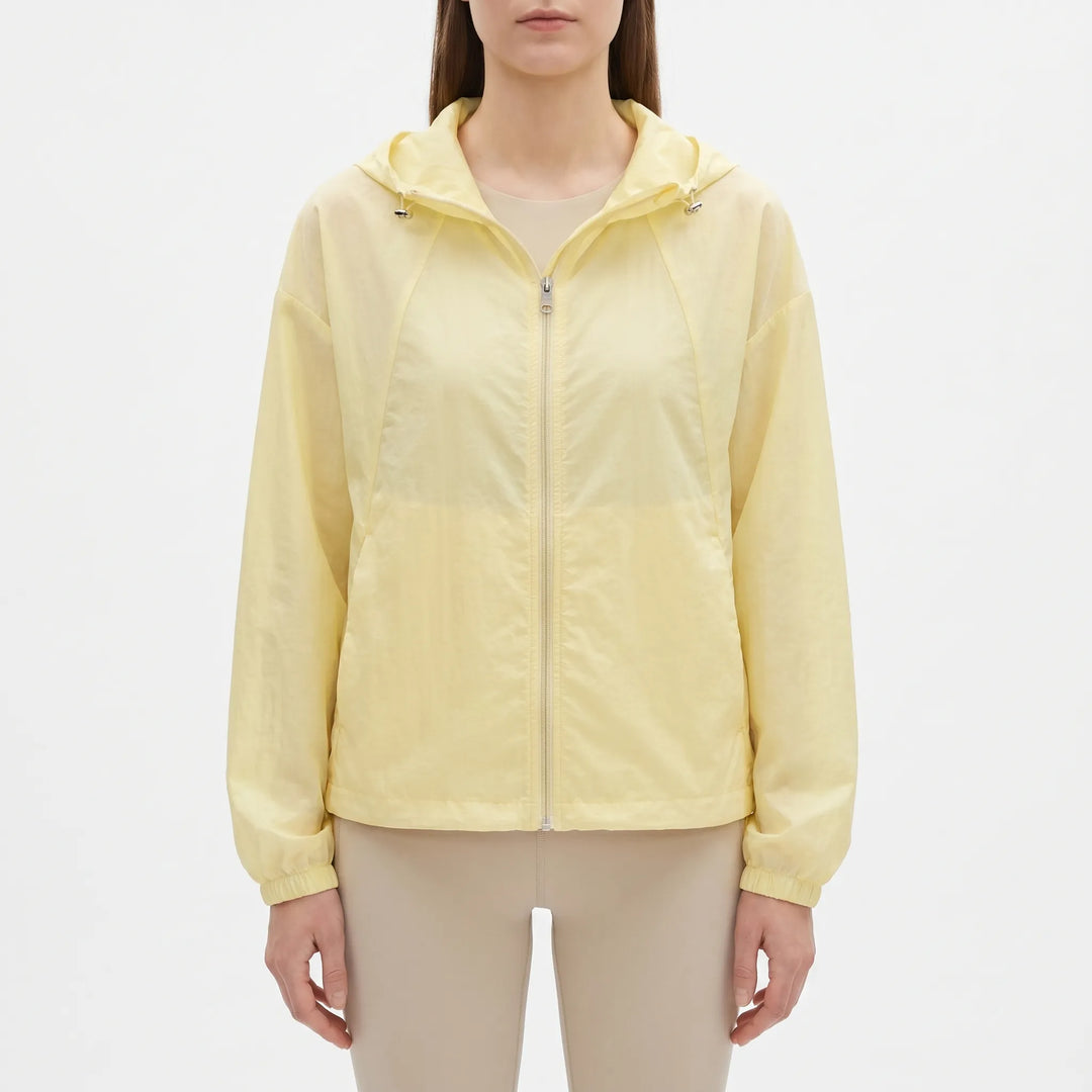 Sporty ladies hooded windbreaker, lightweight and perfect outerwear for casual activities in transitional weather.